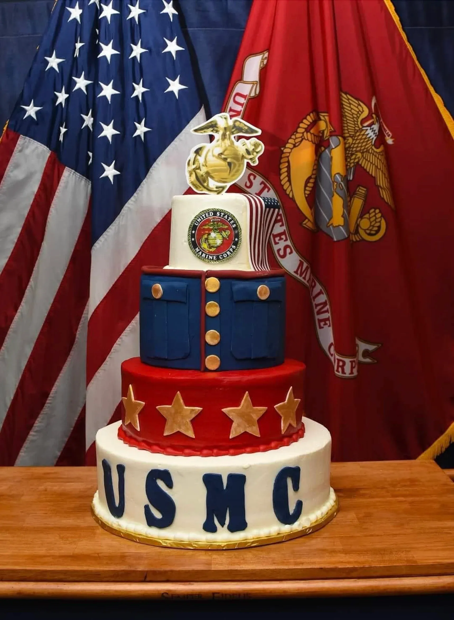Marine Corps Birthday cake displayed with American and Marine Corps flags